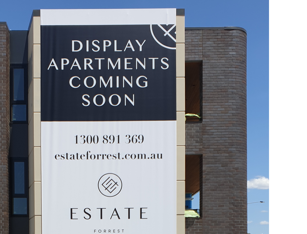 A sign on the side of a building that says display apartments coming soon A sign on the side of a building that says display apartments coming soon
