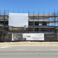 A building under construction with a sign that says estate on it