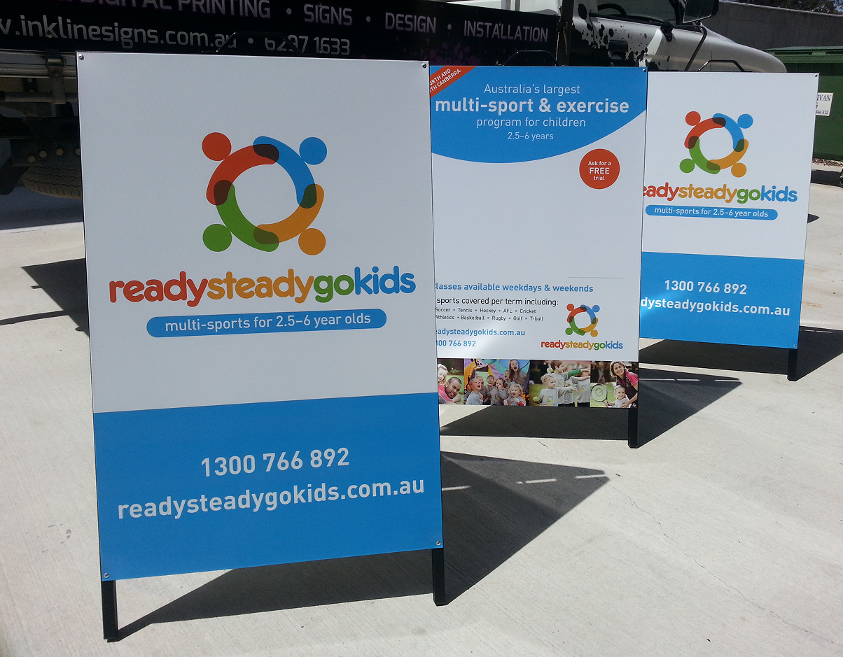 Three readysteadygokids signs are sitting on a concrete surface Three readysteadygokids signs are sitting on a concrete surface