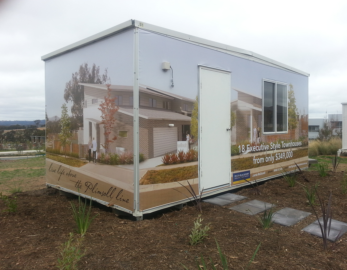 A small building with a picture of a house on it A small building with a picture of a house on it