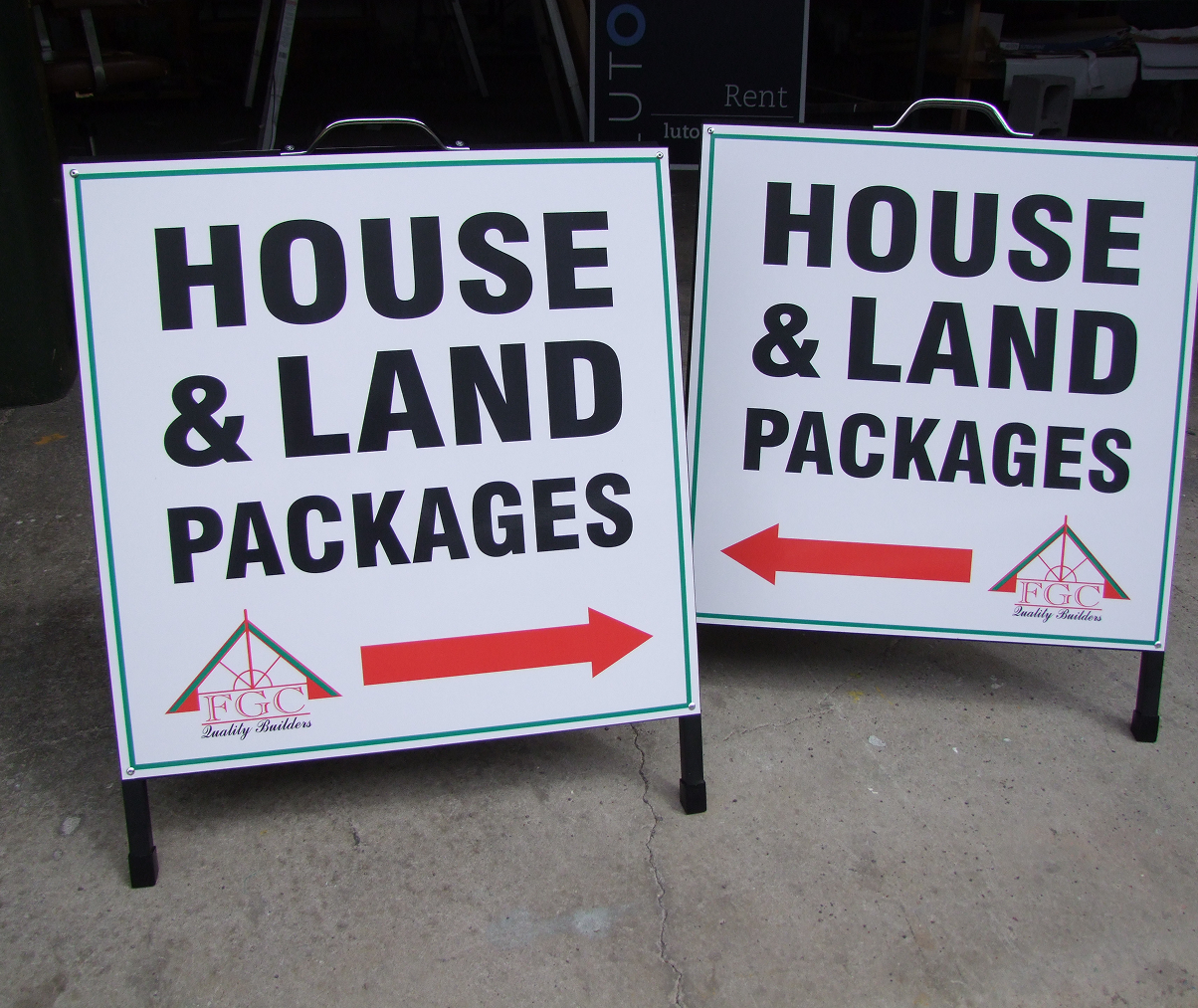 A couple of signs that say house and land packages A couple of signs that say house and land packages