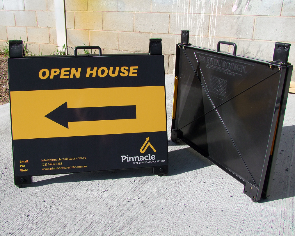 A black and yellow sign that says open house