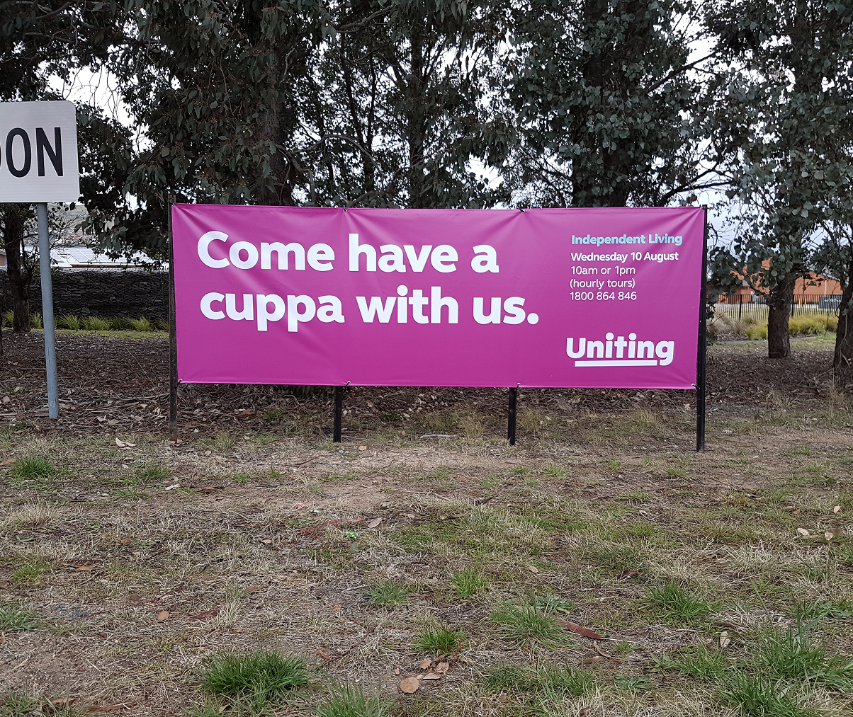 A billboard that says come have a cuppa with us