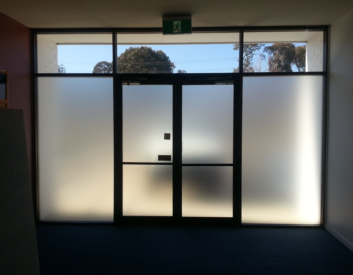 A door with a green exit sign above it A door with a green exit sign above it