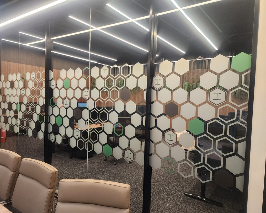A conference room with a honeycomb design on the glass walls. A conference room with a honeycomb design on the glass walls.