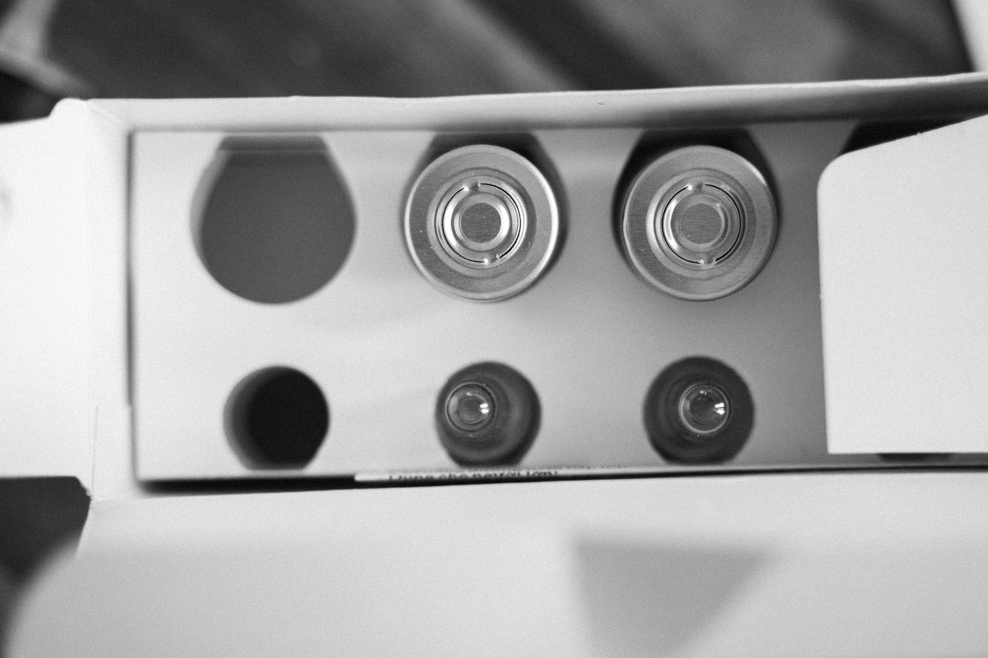 A black and white photo of a box with a few holes in it