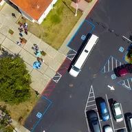 An aerial view of a parking lot with a limousine parked in it.