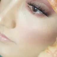 A close up of a woman 's face with makeup on.