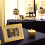 A table with three cakes and a picture on it.