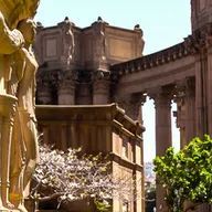 There are a lot of statues in front of a building.