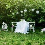 There is a table and chairs in the middle of the grass.