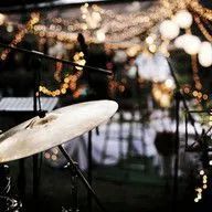 A drum set is sitting on a stage in front of a microphone.