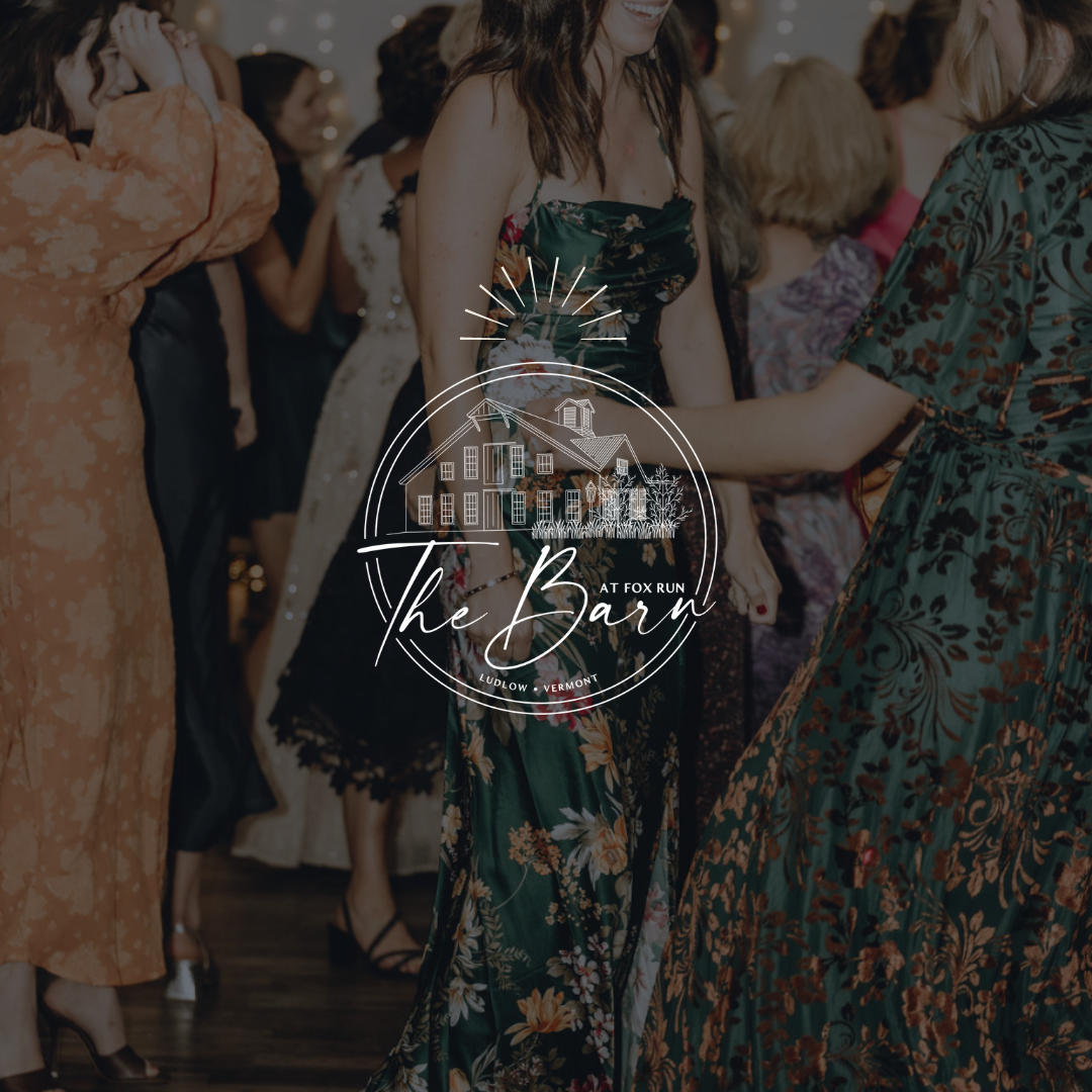 A group of women are dancing in front of a sign that says the barn