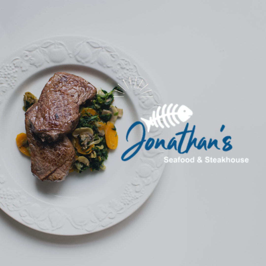 Jonathan 's seafood and steakhouse has a white plate with meat and vegetables on it