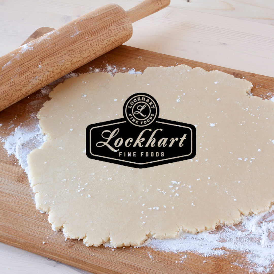 A logo for lockhart fine foods is on a piece of dough