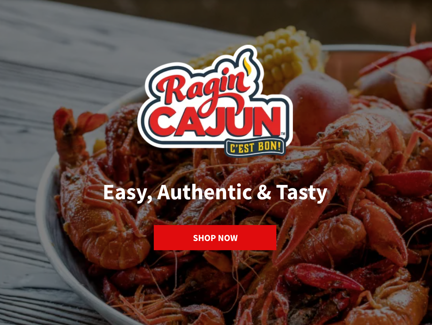 A website for ragin cajun shows a plate of shrimp and corn on the cob