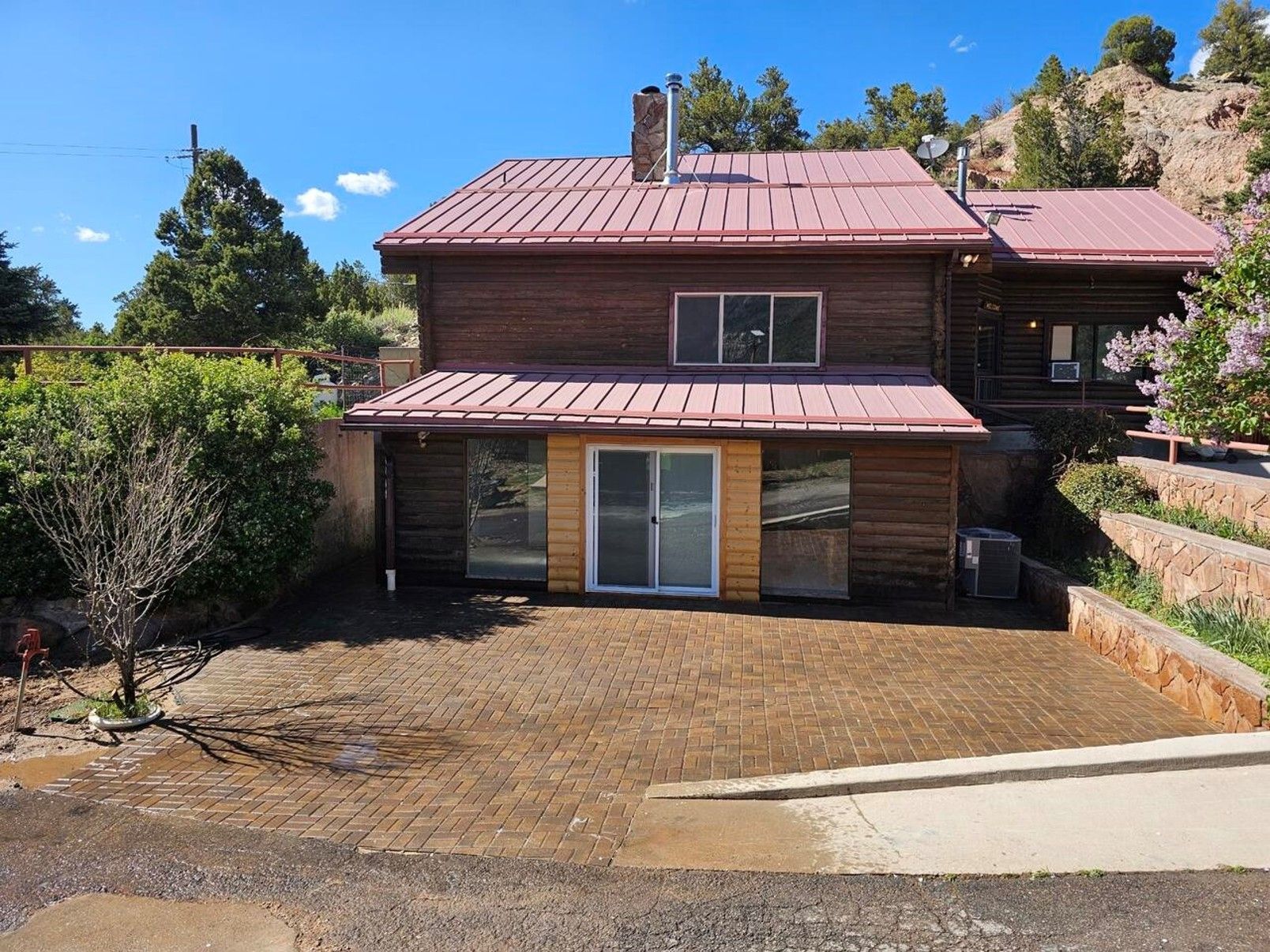 A house with a red roof and a sliding glass door