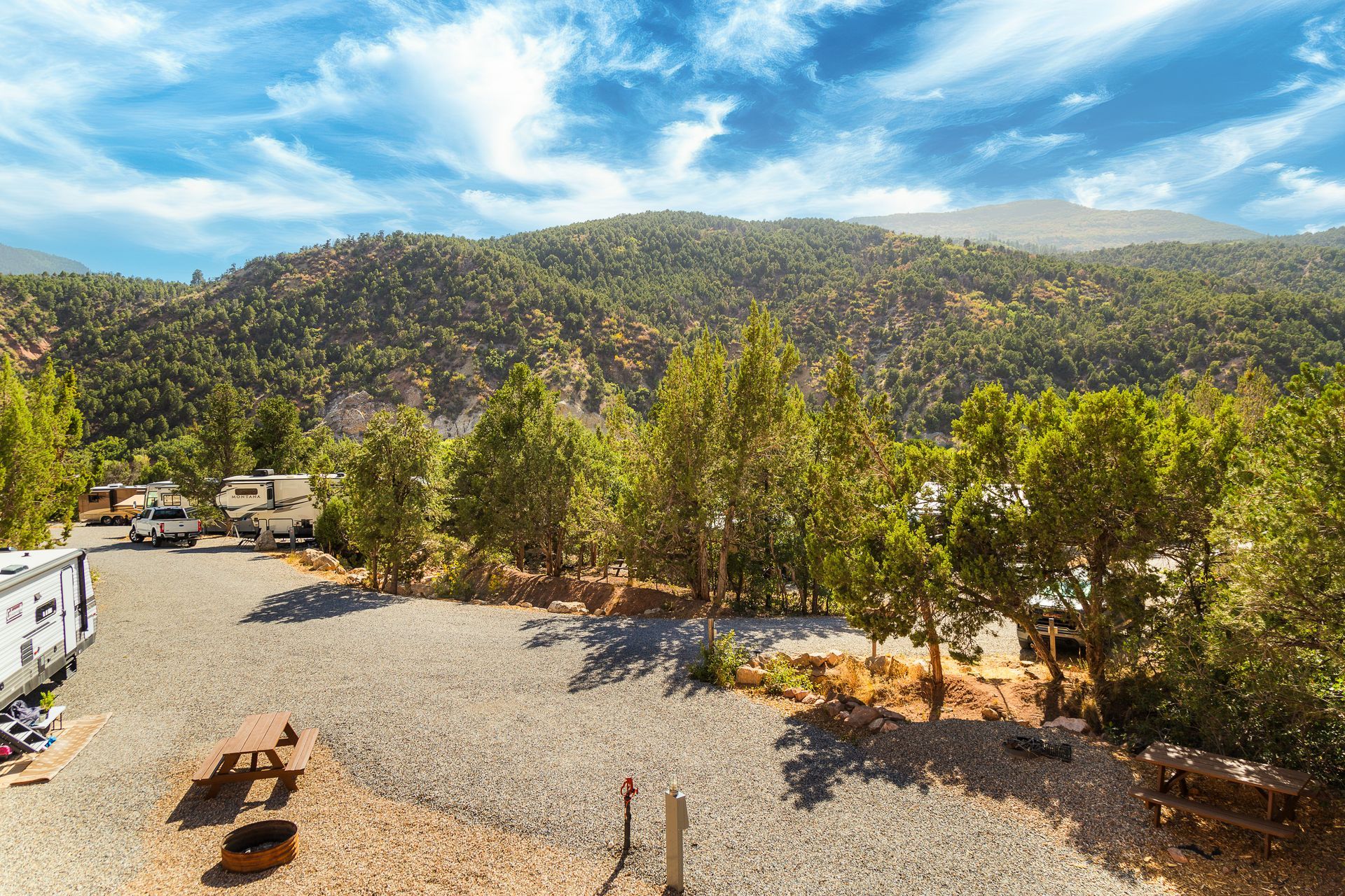 An aerial view of a campground with mountains in the background.