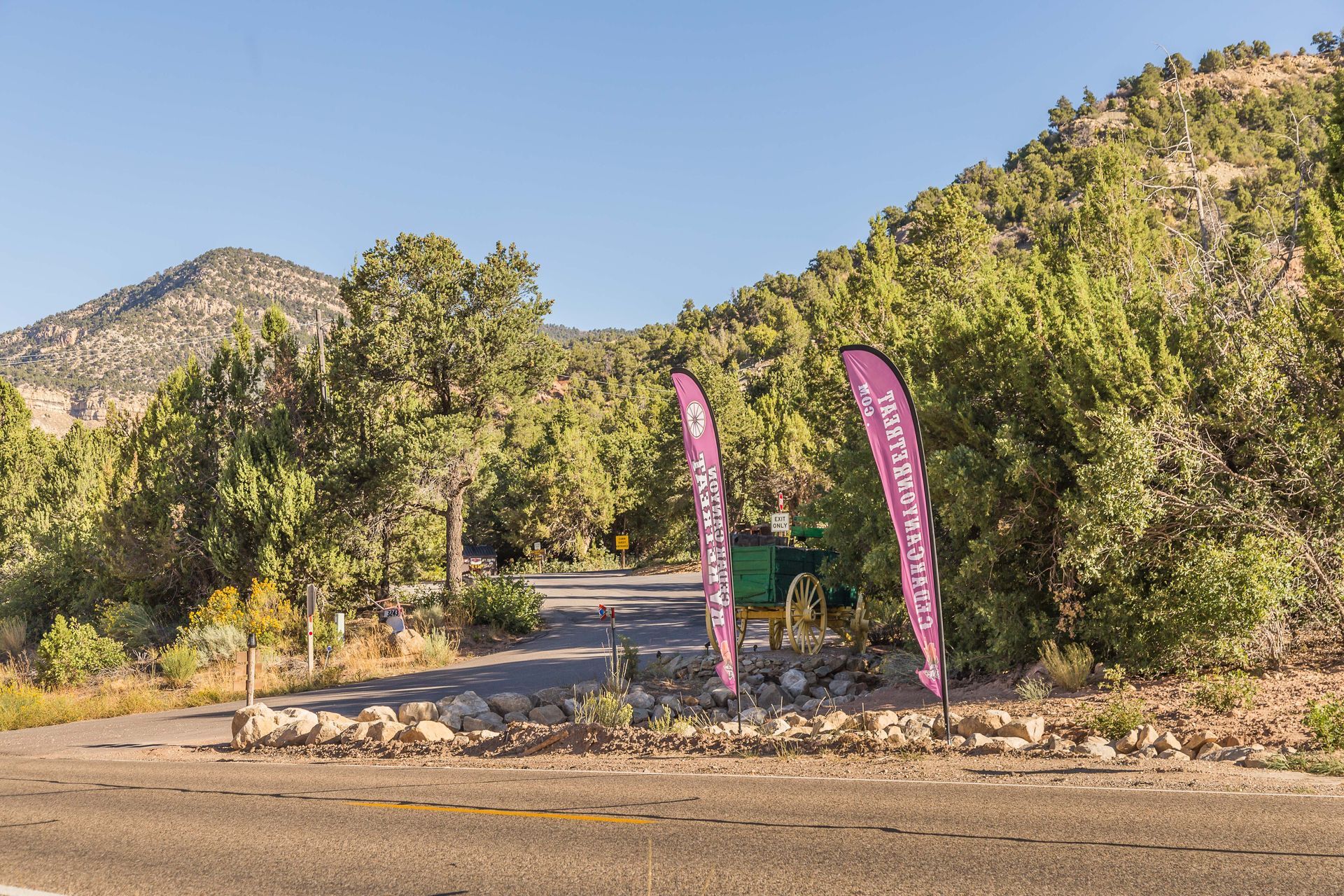 A couple of flags are sitting on the side of a road.