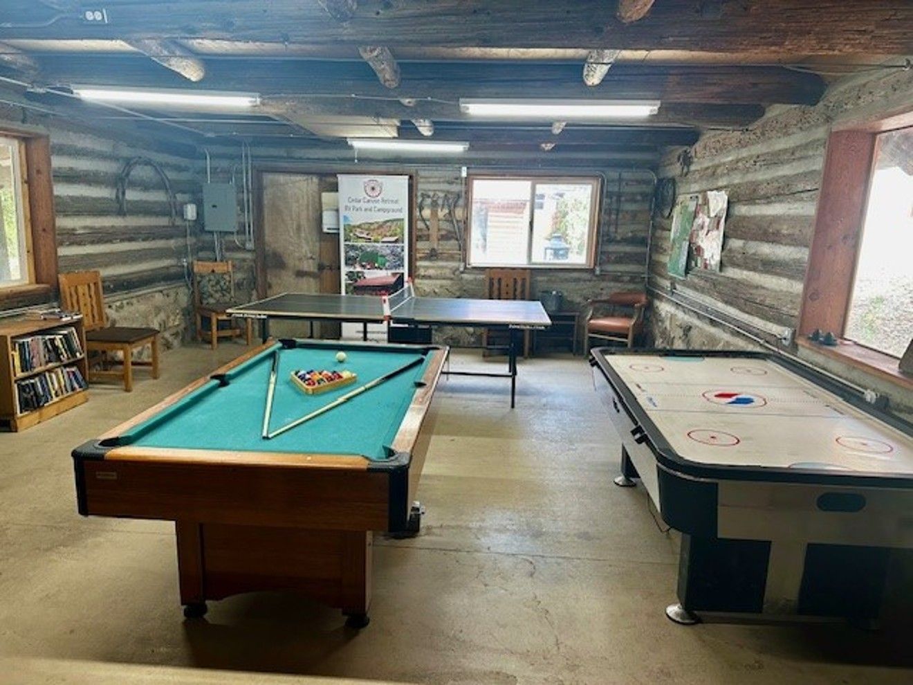 There is a pool table and an air hockey table in the room.