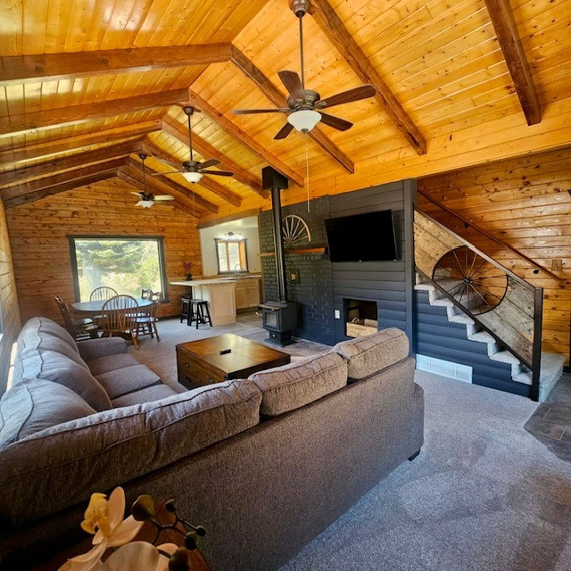 A living room with a couch and a ceiling fan