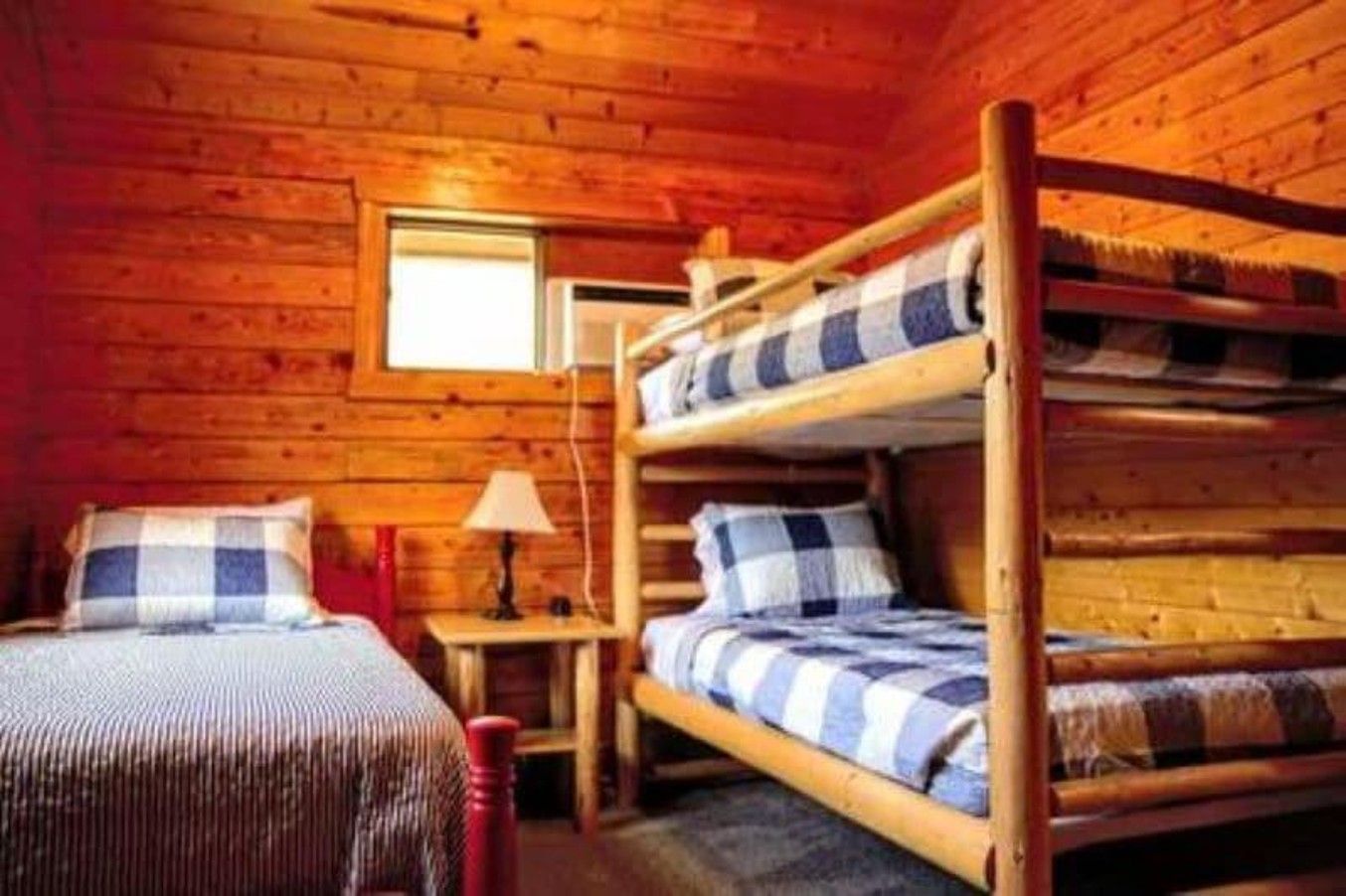 A bedroom with two bunk beds and a single bed