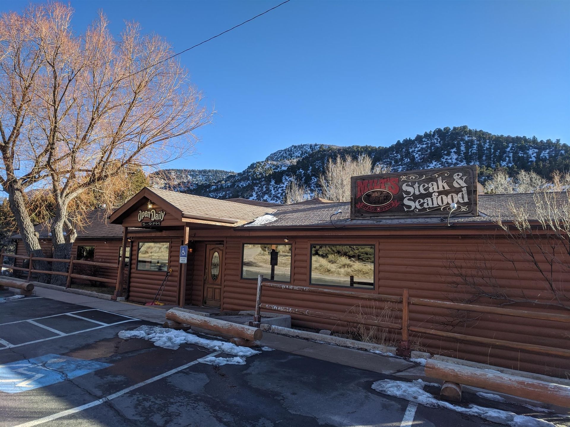 A sunset over a mountain range with a lot of fog
