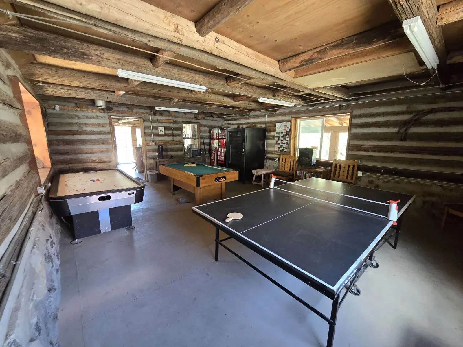 There is a ping pong table in the middle of the room.