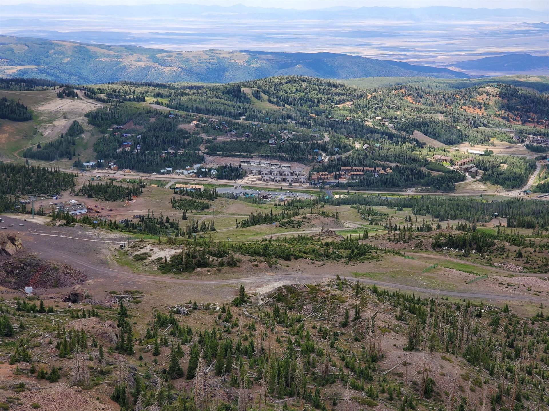 A sunset over a mountain range with a lot of fog