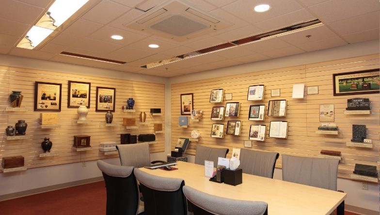 A conference room with a table and chairs and pictures on the wall