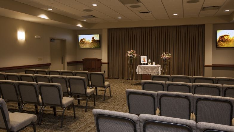 A room with rows of chairs and a podium in the middle