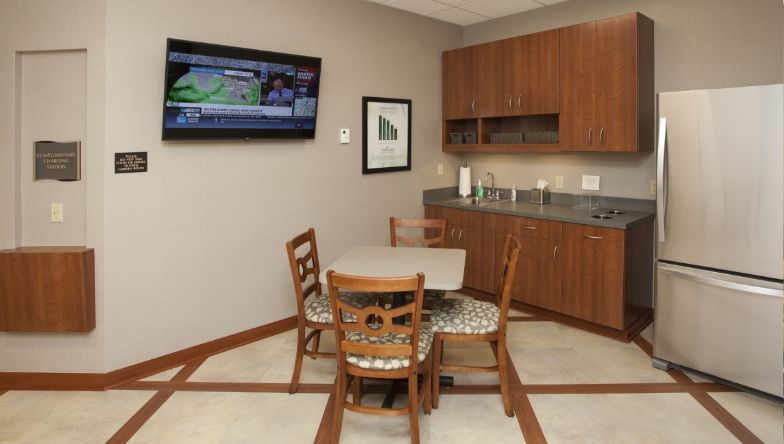 A kitchen with a table and chairs and a refrigerator