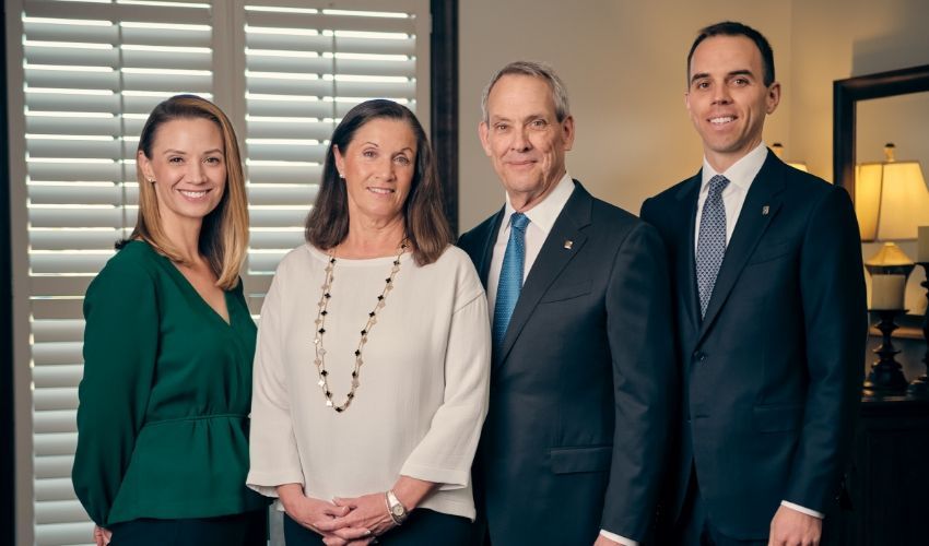 A group of people in suits and ties are posing for a picture.