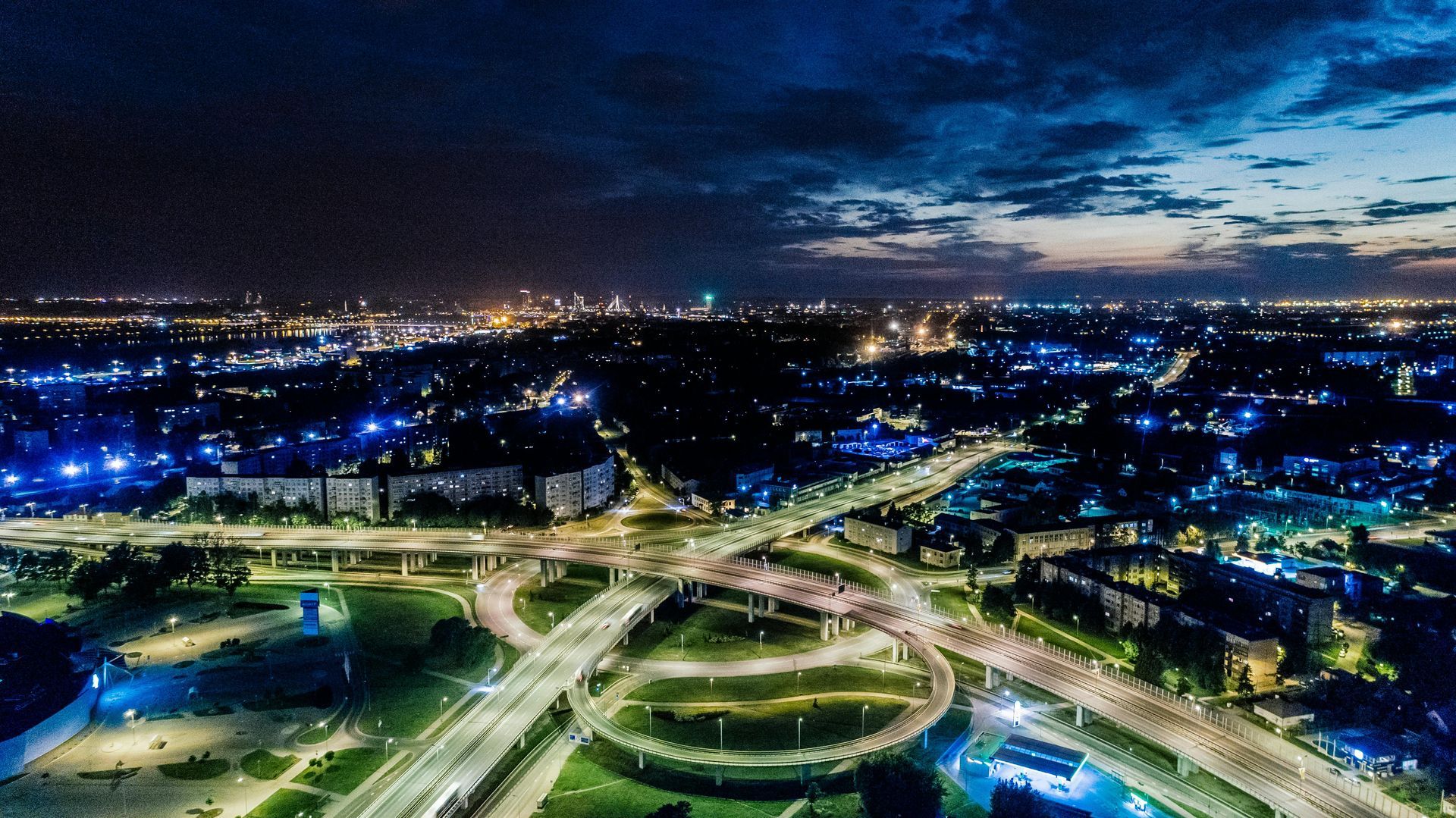 An aerial view of a city at night with a lot of traffic.