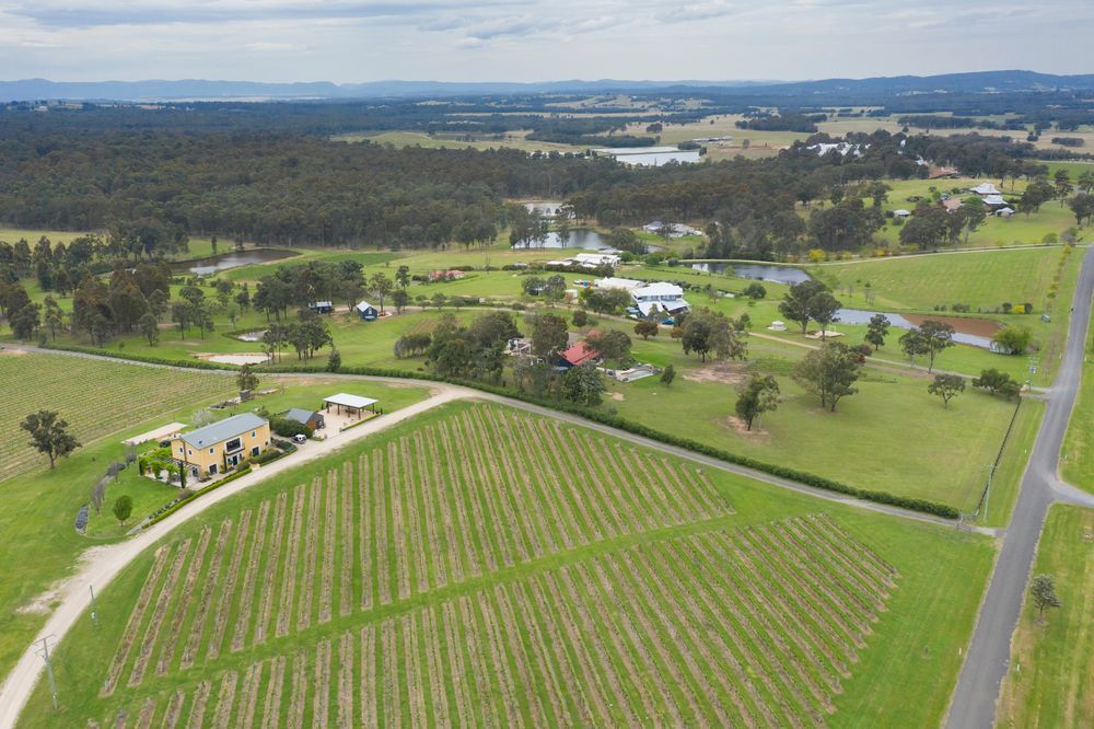 A Woman Is Opening A Door With A Key — GMS Legal & Conveyancing In Hunter Valley, NSW