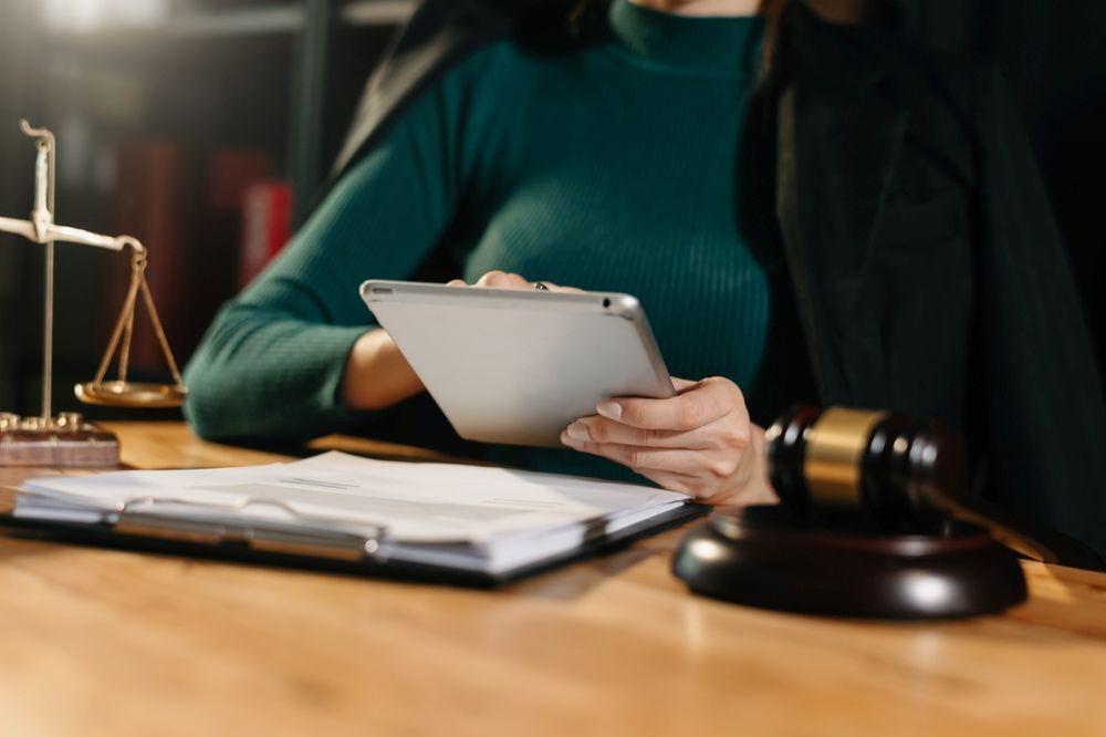 A Woman Is Using A Tablet Computer — GMS Legal & Conveyancing In Central Coast, NSW