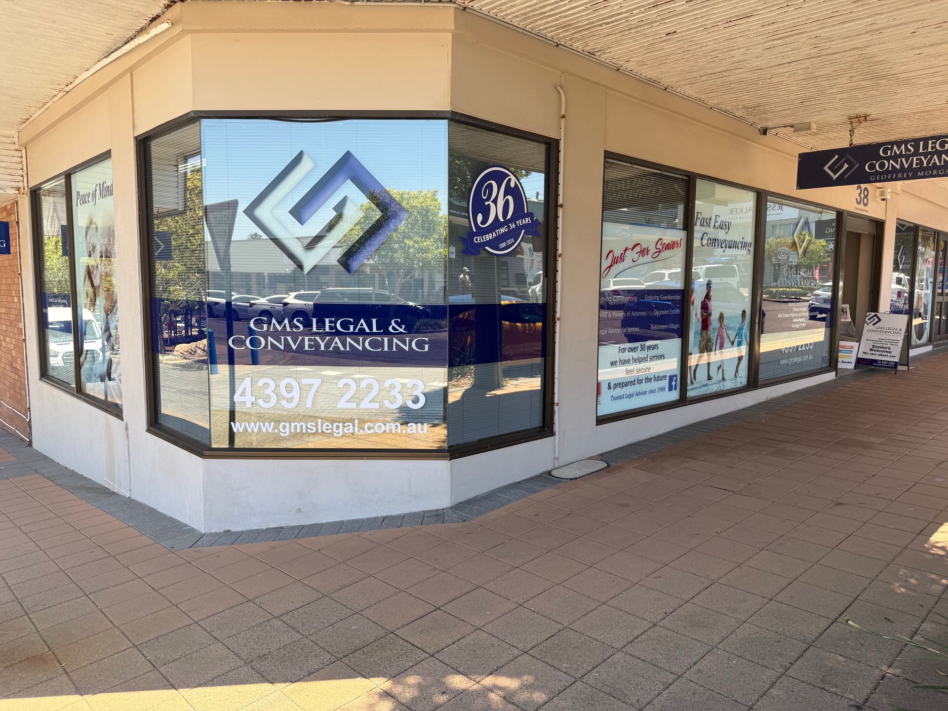 A Couple Is Shaking Hands With A Woman — Gms Legal & Conveyancing In 38 Canton Beach Rd, Toukley