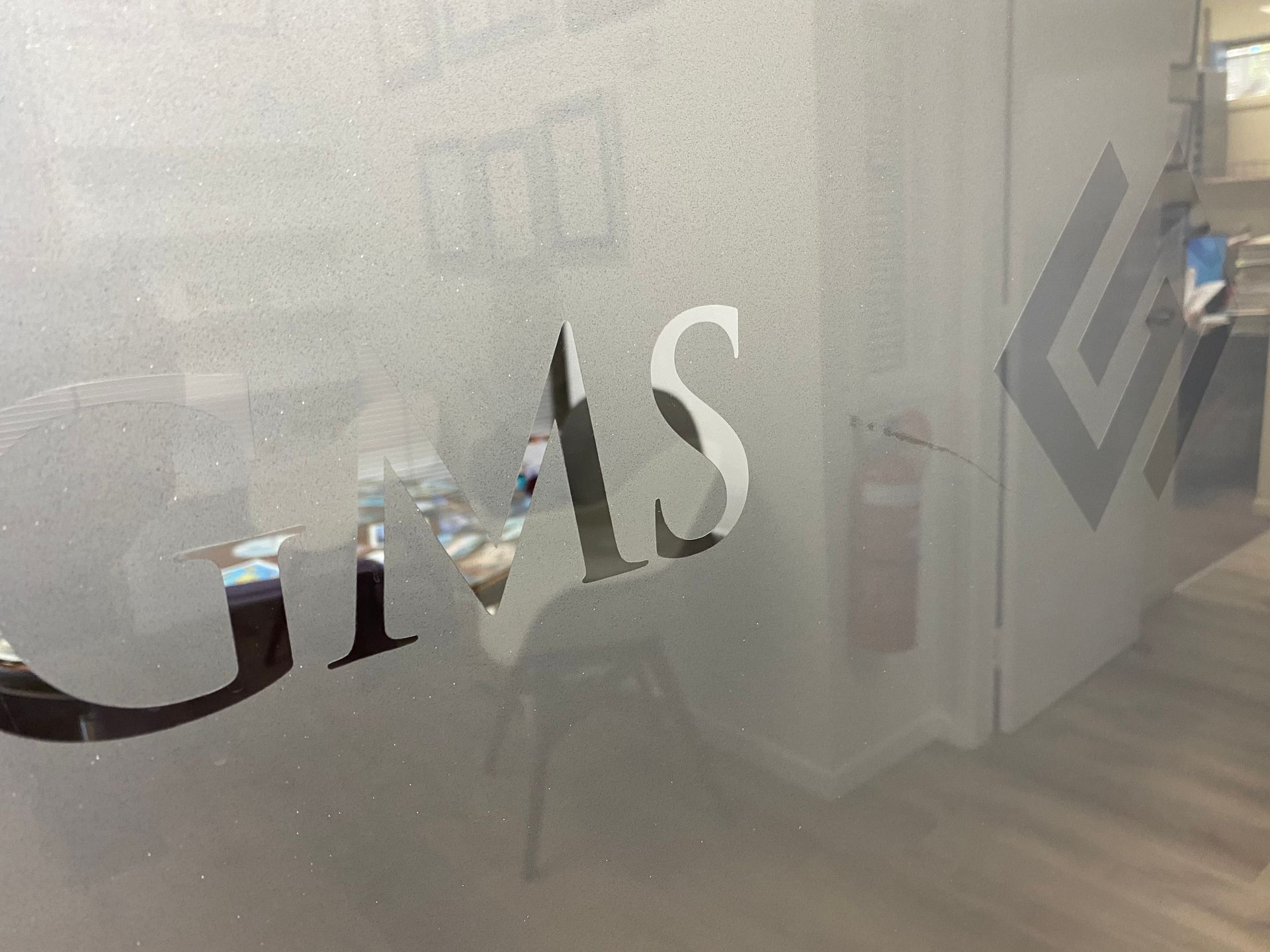 Frosted glass office door with the letters 