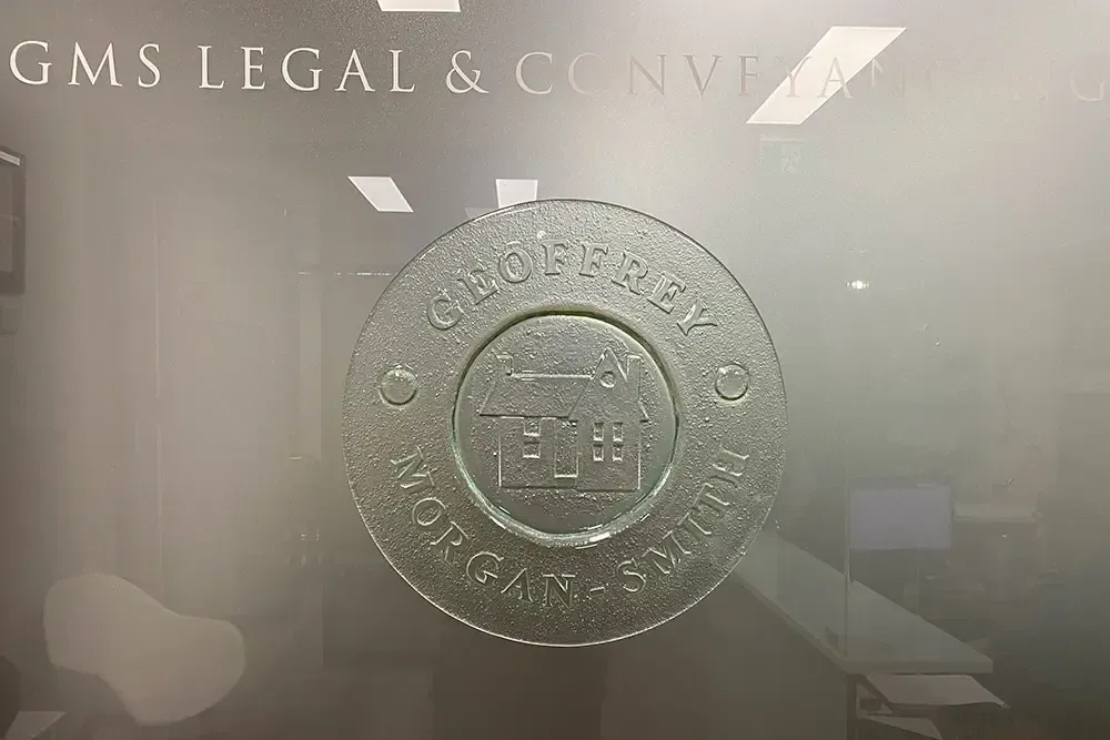 A Gms Legal & Conveyance Logo Is On A Glass Door — GMS Legal & Conveyancing In 38 Canton Beach Rd, Toukley
