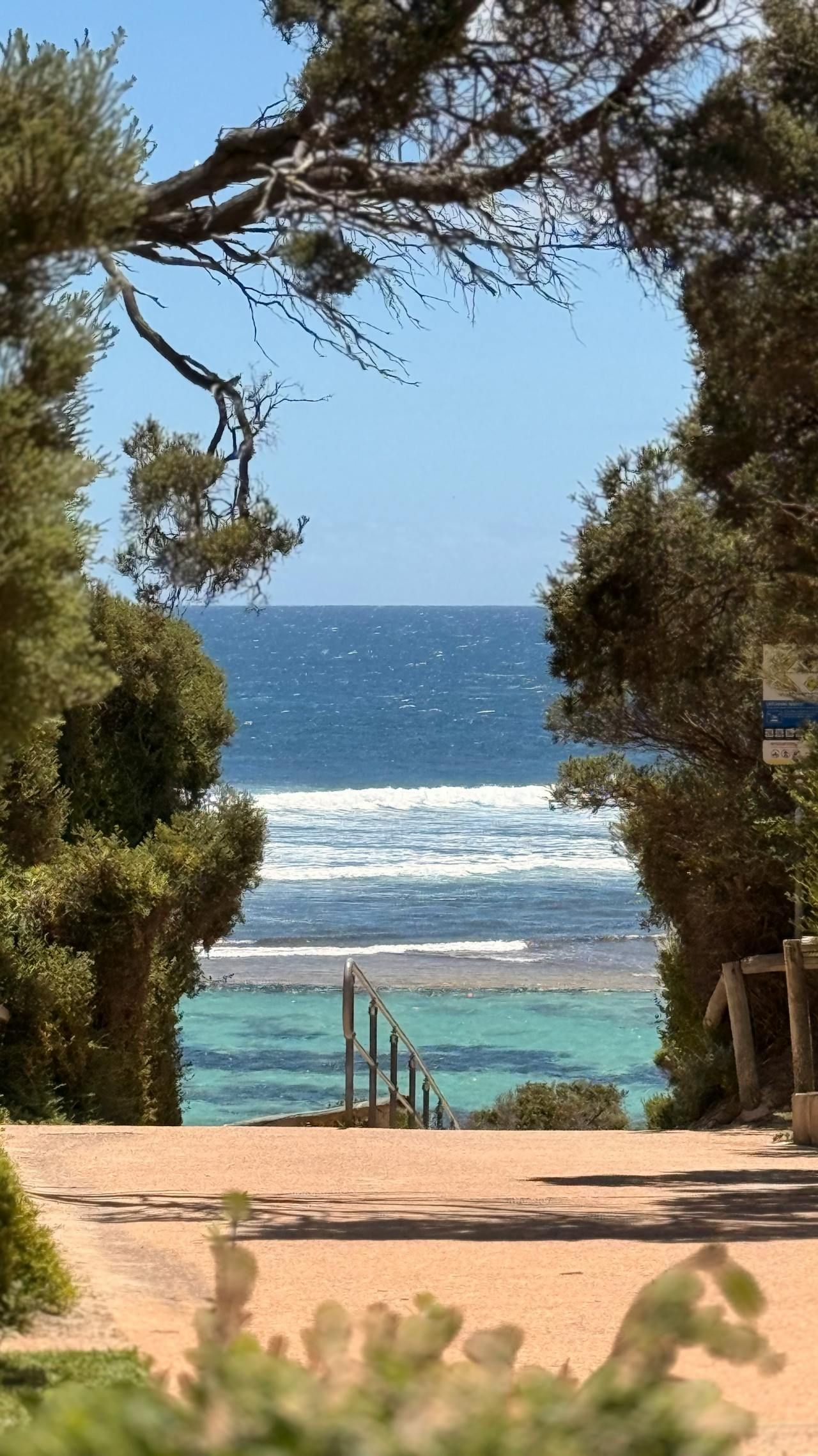 A Woman Is Shaking Hands With A Man In Front Of A Model House — GMS Legal & Conveyancing In Lake Macquarie, NSW