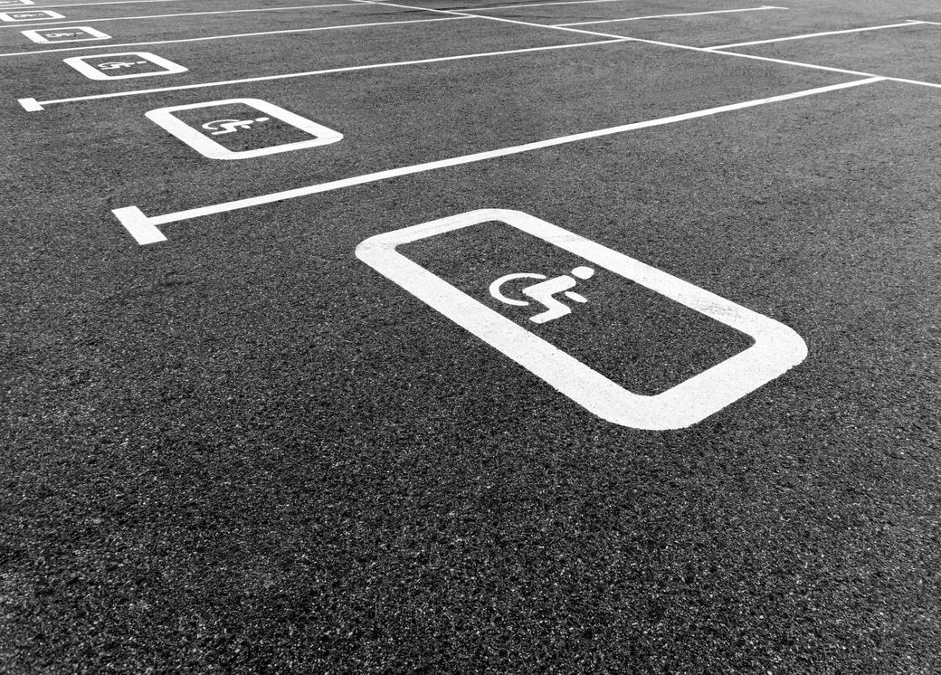 Empty accessible parking spaces marked in white on asphalt pavement