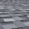 Gray asphalt shingle roof with varying shades, perspective angled upward.