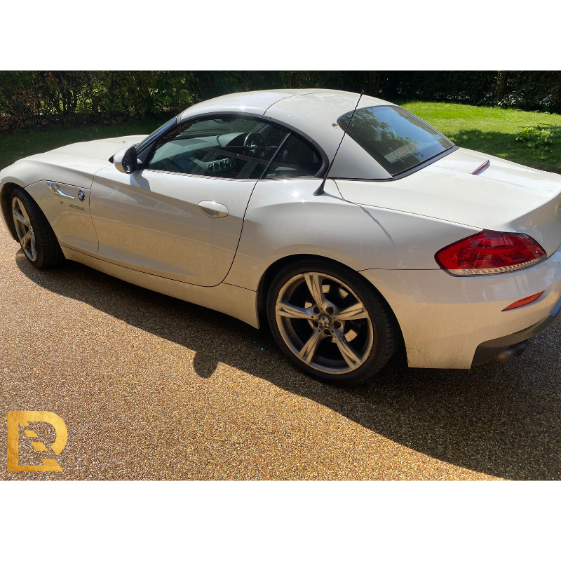 image of a green car driving Bluewater island for restex website home picture
