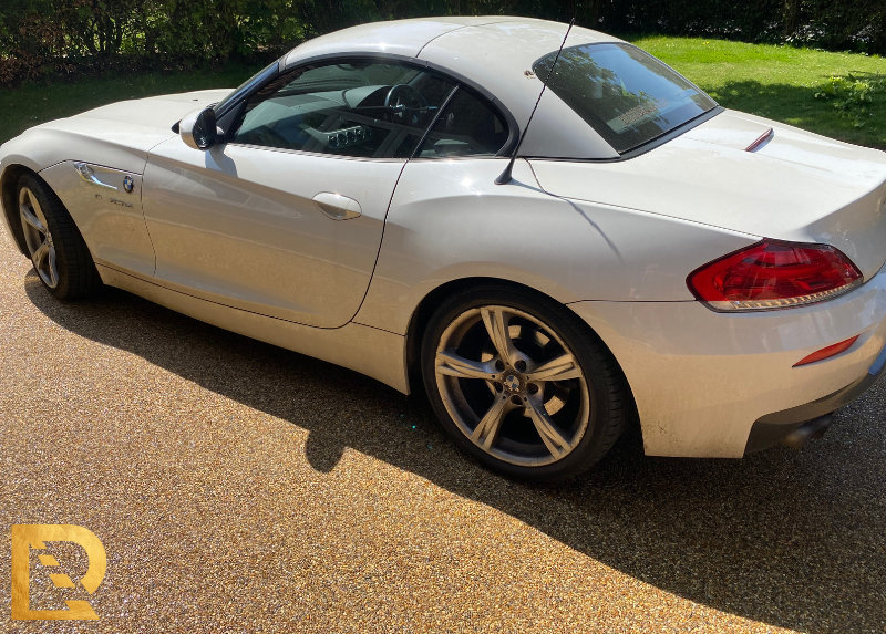 white car parked on a UV Resin bound driveway IN UK