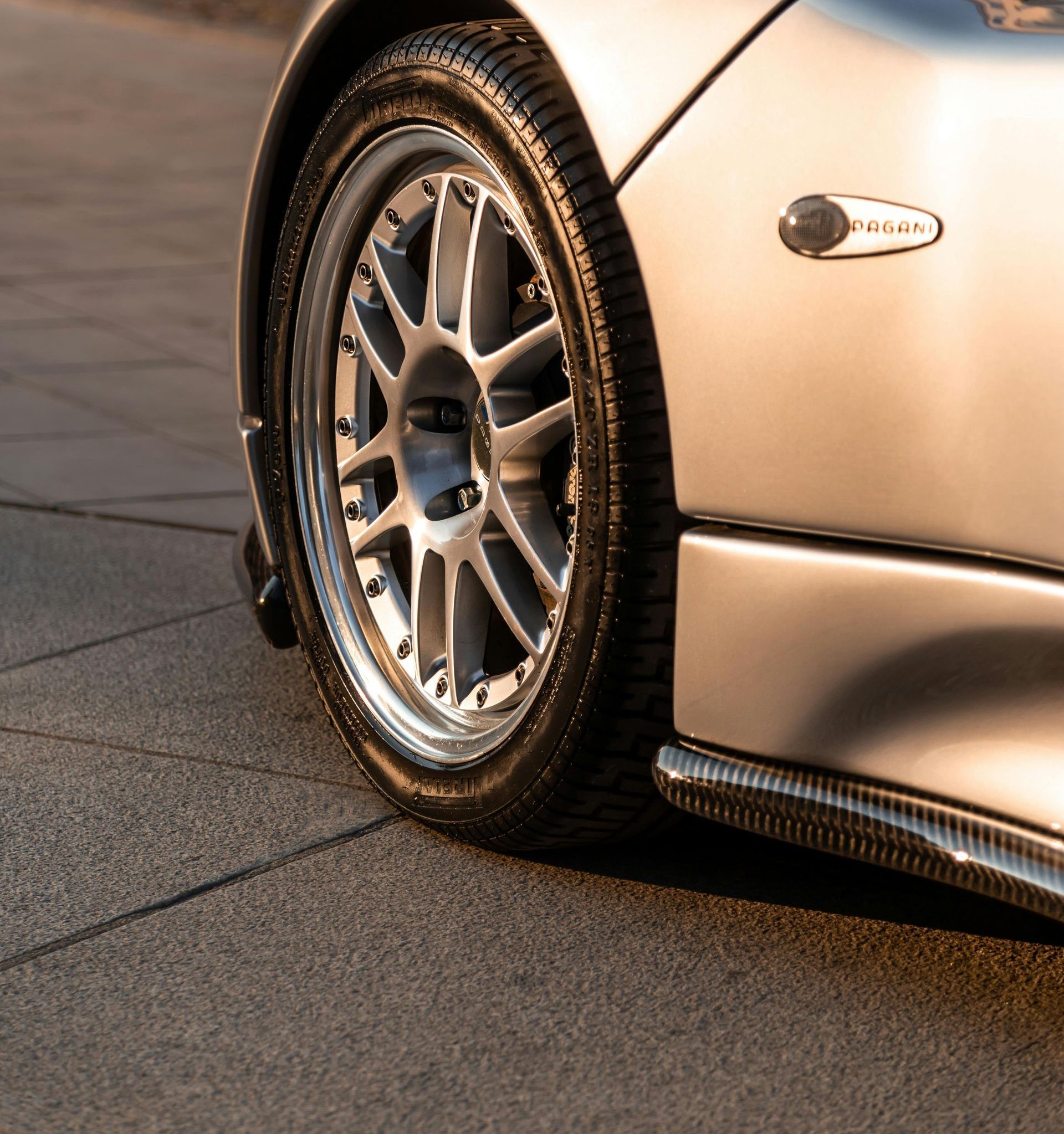 A silver sports car is parked on the side of the road