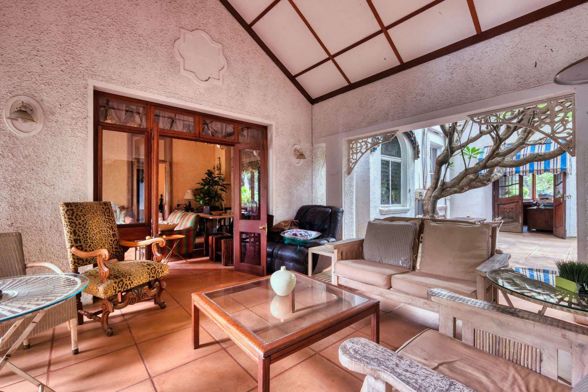 A living room with a couch , chairs , and a coffee table.