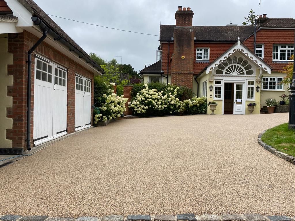 A large house with a gravel driveway leading to it