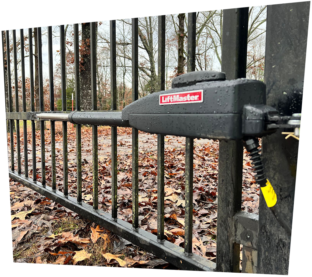 A black wrought iron fence surrounds a lush green field.