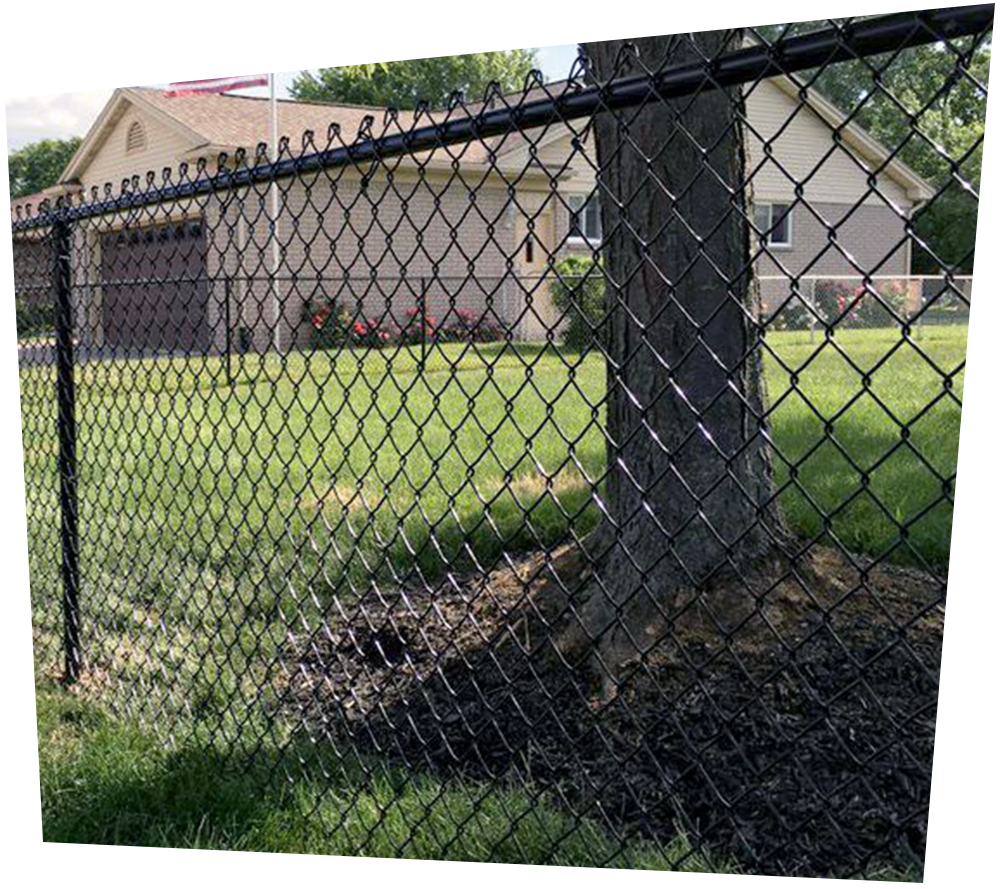 A white vinyl fence with a tree in the background