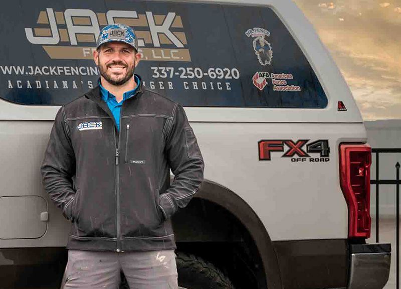 A man is standing in front of a white truck.